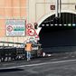 A worker walks near a tunnel before the opening of the new San Giorgio bridge for vehicles