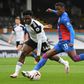 Fulham defender Ola Aina fails to prevent Crystal Palace winger Wilfried Zaha (R) unleashing a shot
