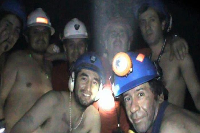 In this handout file photo released by Chile's mining ministry and taken on September 17, 2010, trapped Chilean miners pose inside the San Jose mine during their harrowing ordeal
