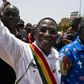 Soumaila Cisse greets supporters on a march in Bamako in 2018