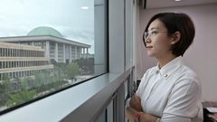 Jang Hye-yeong looks out of her office window towards South Korea's legislature, which she called 'an institution made up of middle-aged, able-bodied men'