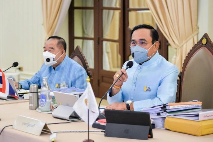 Thai Prime Minister Prayut Chan-O-Cha (R) attends a cabinet meeting Thursday