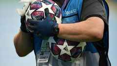 A member of the ground staff disinfects a ball before the Champions League last 16 match between Manchester City and Real Madrid at the Etihad Stadium in Manchester on August 7