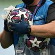 A member of the ground staff disinfects a ball before the Champions League last 16 match between Manchester City and Real Madrid at the Etihad Stadium in Manchester on August 7