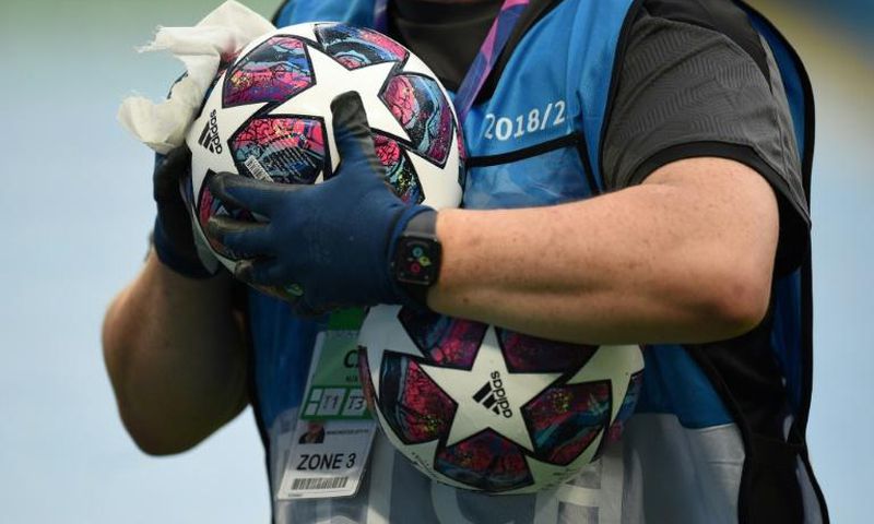 A member of the ground staff disinfects a ball before the Champions League last 16 match between Manchester City and Real Madrid at the Etihad Stadium in Manchester on August 7