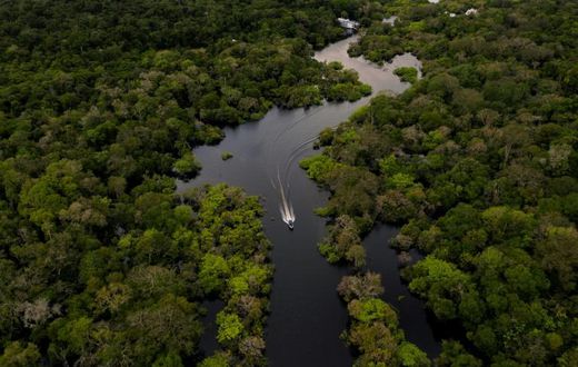 A boat travels on the Jurura river in Carauari, in the heart of the Brazilian Amazon rainforest, in March 2020 -- the entire region is facing many challenges, and now must battle the coronavirus crisis as well