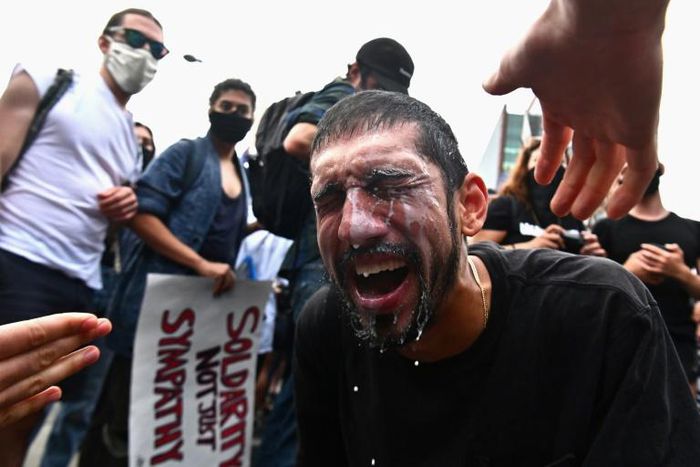 A protester has milk splashed in his eyes after being hit by tear gas during a Black Lives Matter protest in New York on May 29