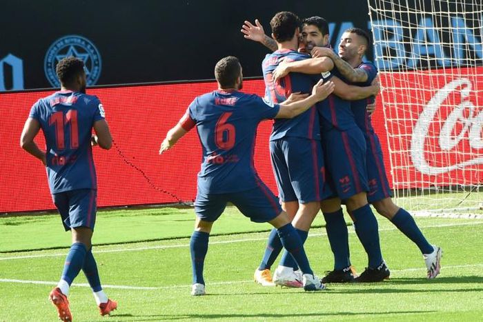 Luis Suarez (C) celebrates after scoring against Celta Vigo on Saturday.