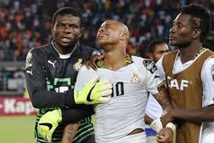 Fatau Dauda on the left and Asamoah Gyan on the right consoling Andre Ayew in the middle at AFCON 2015