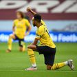 Arsenal striker Pierre-Emerick Aubameyang kneels before a Premier League match