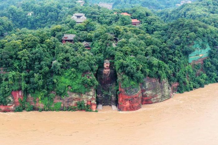 State media footage showed murky floodwaters lapping at the feet of the 71m metre-tall Leshan Giant Buddha in Sichuan - for the first time since the People's Republic of China was founded in 1949