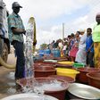 A supplier distributes water from a tanker truck to residents of Bouake at the start of July 2018