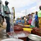 A supplier distributes water from a tanker truck to residents of Bouake at the start of July 2018