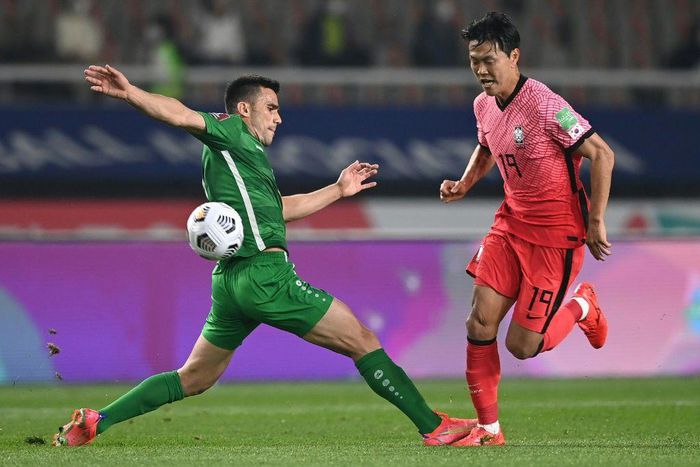 Chasing shadows: Kim Young-gwon, one of South Korea's scorers, skips past Annadurdyyev Altymyrat of Turkmenistan