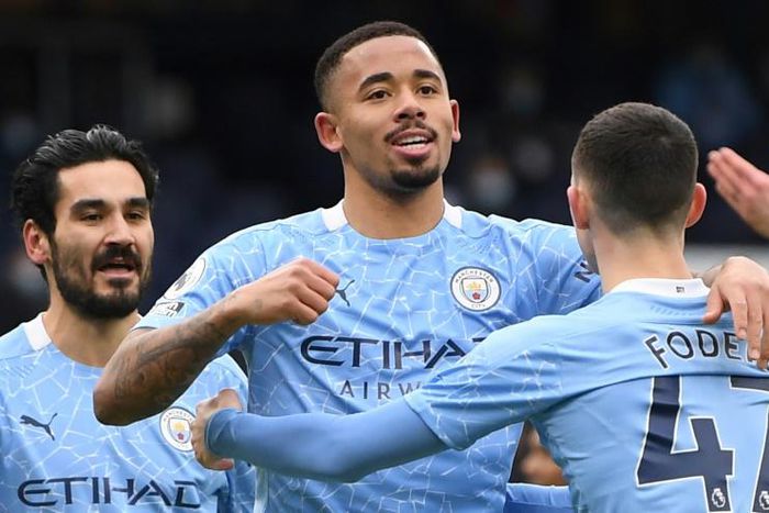 Manchester City striker Gabriel Jesus (C) celebrates scoring