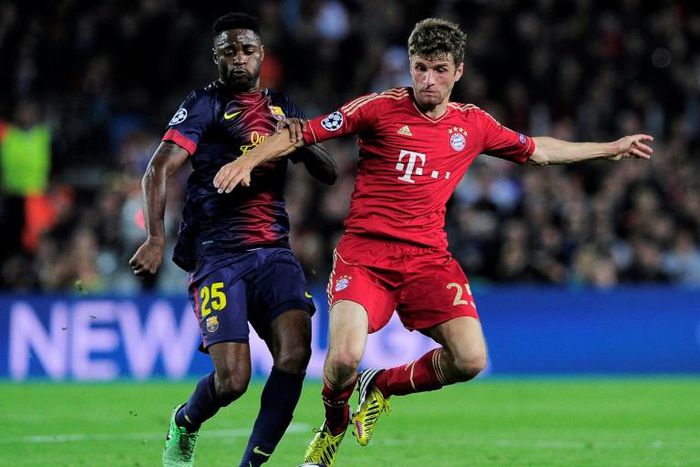 Alex Song (L) playing for Barcelona in a 2013 Champions League semi-final against Bayern Munich.