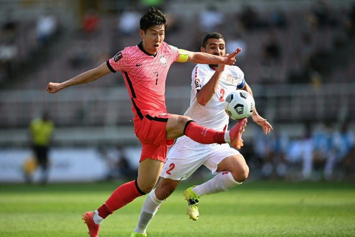 South Korea's Son Heung-min (L) and Lebanon's Kassem El Zein compete for the ball