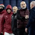 Genoa coach Rolando Maran (R) shakes hands with AC Milan's Stefano Pioli on December 16, 2020.