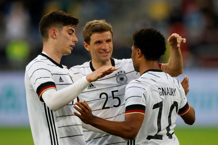 Kai Havertz (L) and Thomas Mueller (C) celebrate with Germany goalscorer Serge Gnabry in a Euro 2020 warm-up win over Latvia