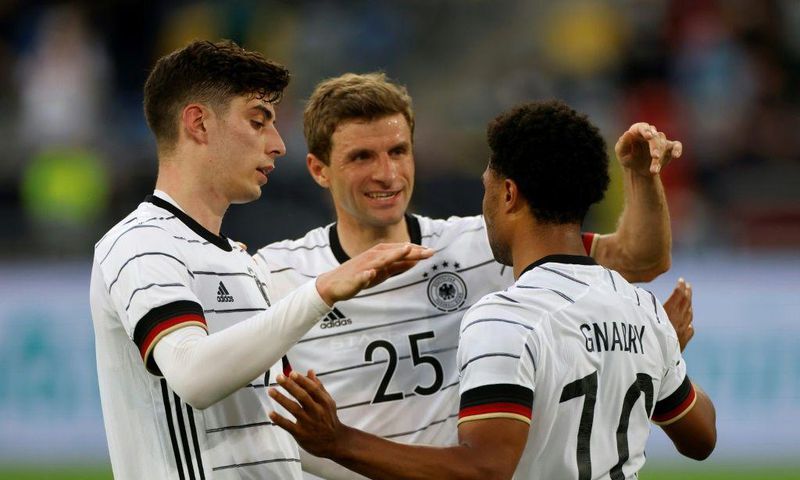 Kai Havertz (L) and Thomas Mueller (C) celebrate with Germany goalscorer Serge Gnabry in a Euro 2020 warm-up win over Latvia