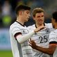 Kai Havertz (L) and Thomas Mueller (C) celebrate with Germany goalscorer Serge Gnabry in a Euro 2020 warm-up win over Latvia