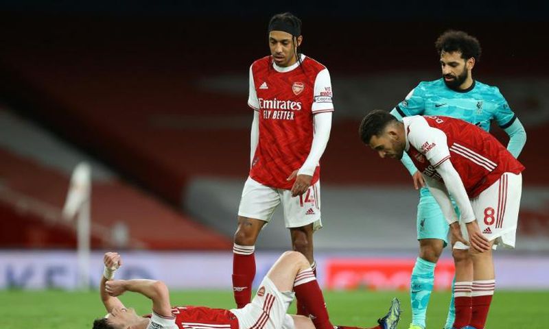 Ligament damage: Arsenal defender Kieran Tierney lies injured during a Premier League match against Liverpool