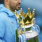 Manchester City striker Sergio Aguero cradles the Premier League trophy
