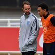 England manager Gareth Southgate (L) speaks with Liverpool defender Trent Alexander-Arnold