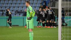 Bayern Munich goalkeeper Manuel Neuer (L) looks on as Kiel's players celebrate during Wednesday's shock German Cup defeat