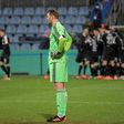 Bayern Munich goalkeeper Manuel Neuer (L) looks on as Kiel's players celebrate during Wednesday's shock German Cup defeat