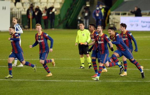 Barcelona celebrate their penalty shootout win over Real Sociedad in the semi-finals of the Spanish Super Cup