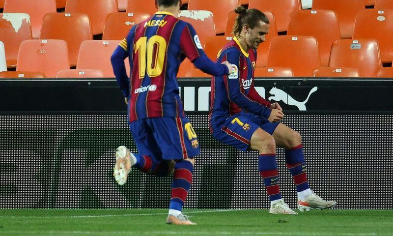 Team work: Lionel Messi runs to celebrate with Antoine Griezmann