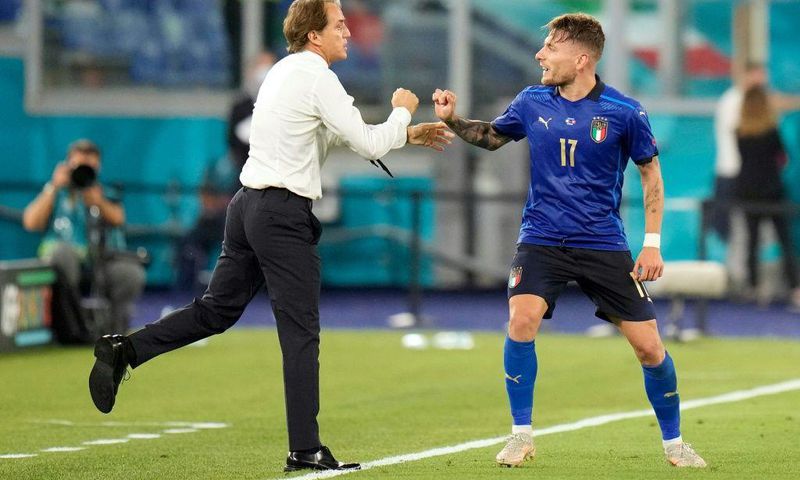 Ciro Immobile (R) celebrates Italy's third goal with coach Roberto Mancini