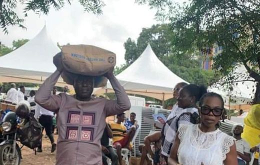 Captain Smart carrying a bag of cement