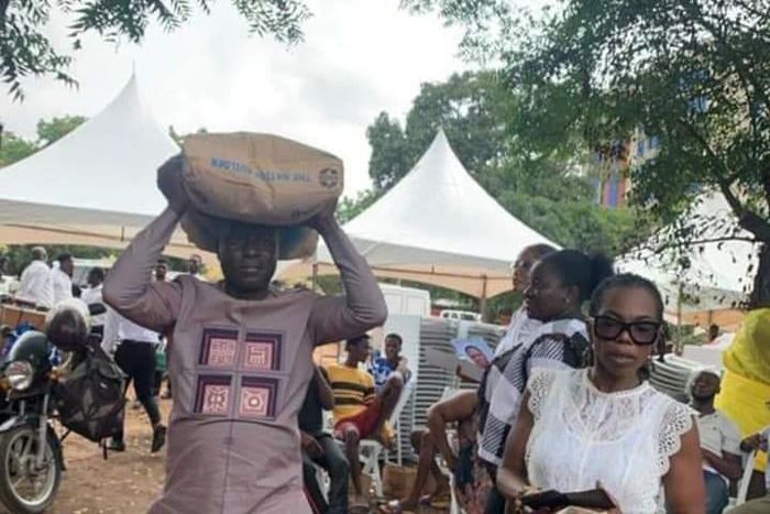 Captain Smart carrying a bag of cement