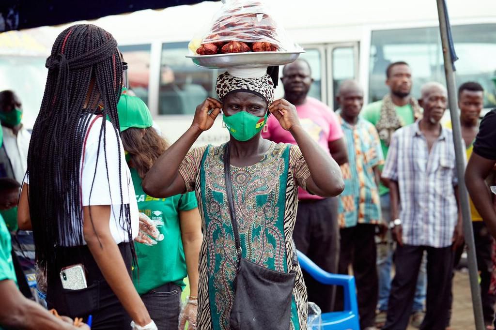 Victoria Michaels giving a face mask to a trader