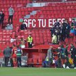 Not so fast: Players in the Sevilla v Granada match return to the pitch to play one more minute
