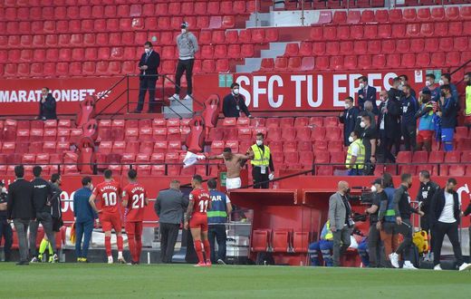 Not so fast: Players in the Sevilla v Granada match return to the pitch to play one more minute