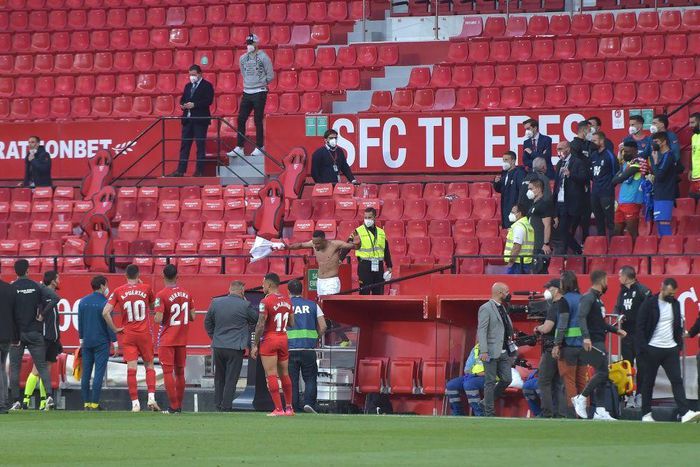 Not so fast: Players in the Sevilla v Granada match return to the pitch to play one more minute