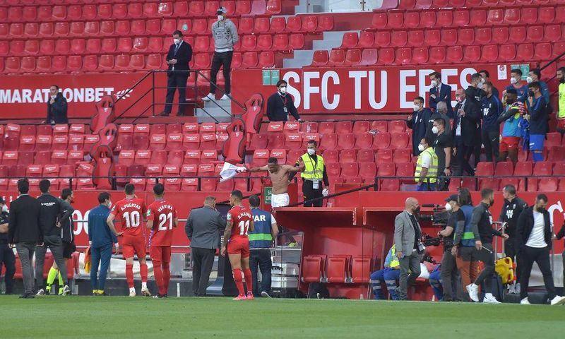 Not so fast: Players in the Sevilla v Granada match return to the pitch to play one more minute