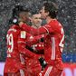 Kingsley Coman (L) celebrates with Thomas Mueller after putting Bayern Munich in front against Hertha Berlin in the snow in the German capital