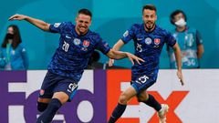 Robert Mak (L) runs off celebrating after his strike helped put Slovakia ahead
