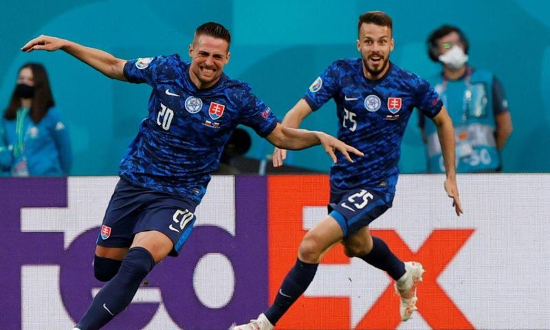 Robert Mak (L) runs off celebrating after his strike helped put Slovakia ahead