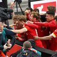 Union Berlin striker Max Kruse (C) is mobbed by team-mates after his winning goal