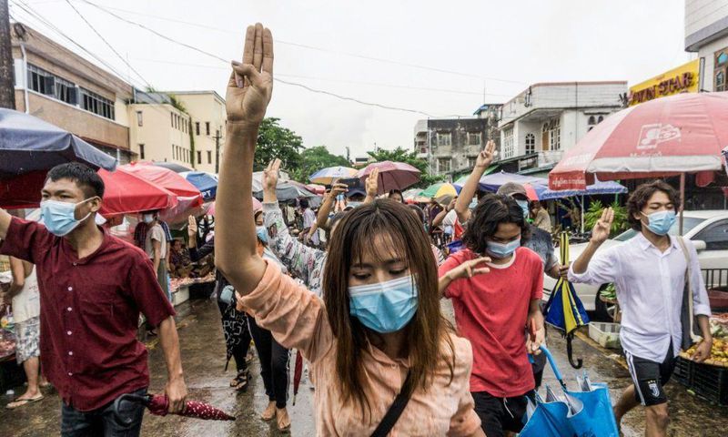 Protesters make the three-finger salute during a demonstration against the military coup in Yangon earlier this month