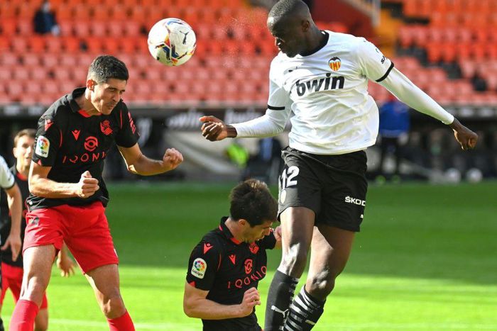 Valencia's French defender Mouctar Diakhaby (right) seen here playing against Real Sociedad walked off the pitch in the game against Cadiz