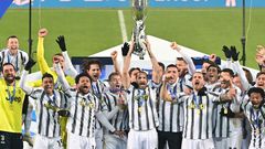Captain Giorgio Chiellini (C) lifts the trophy after Juventus beat Napoli to win the Italian Super Cup