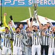 Captain Giorgio Chiellini (C) lifts the trophy after Juventus beat Napoli to win the Italian Super Cup