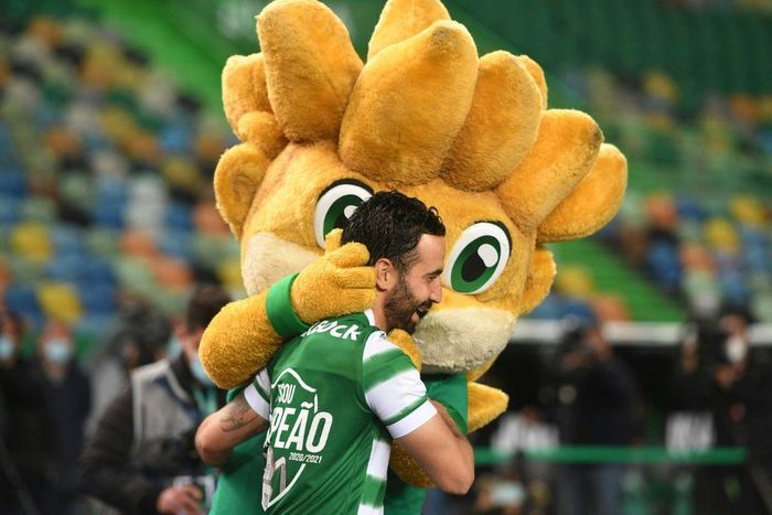 Goalscorer Paulinho celebrates with a furry fan