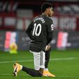 Manchester United forward Marcus Rashford takes a knee